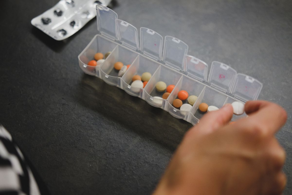 Pills being placed into a pill organizer